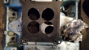 Here you can see using a square bore 4 hole gasket that only a small section of the secondary (top right of the left secondary and top left of the right secondary) needs to be ground down for clearance. The rest of the secondary openings are fine as-is.